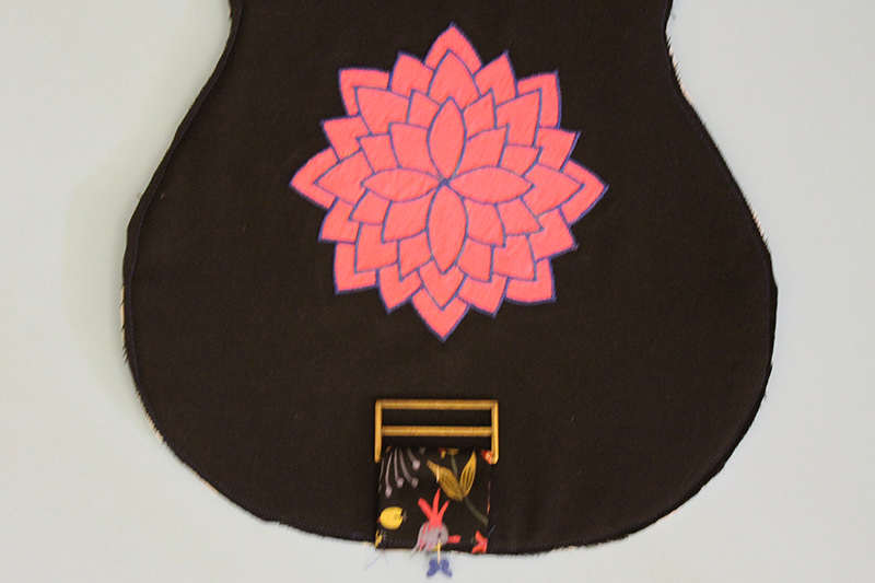 I stitched the Annie and the exterior back together first then I put the "peace, love, uke" embroidery on the back of the headstock section and a cool mandala applique on the body.