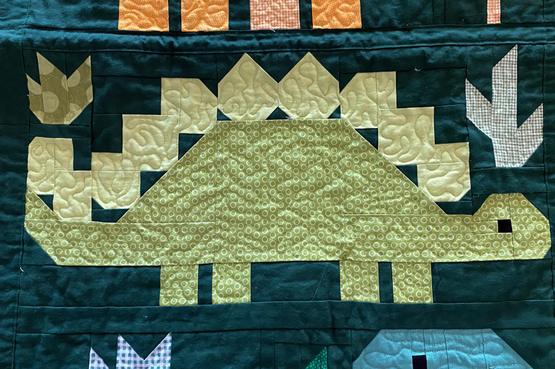 dinosaur quilt with free motion quilting